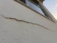 Crack seen from below, render lifting at its edge